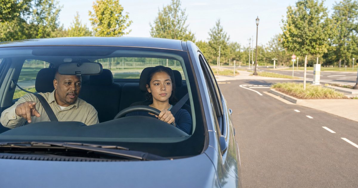 Learner driver practicing with an adult instructor on a quiet road-test course